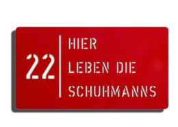 Dies ist ein Bild von einem - Hier leben die Schild - mit weiß glänzender Oberfläche und roter Schriftfarbe